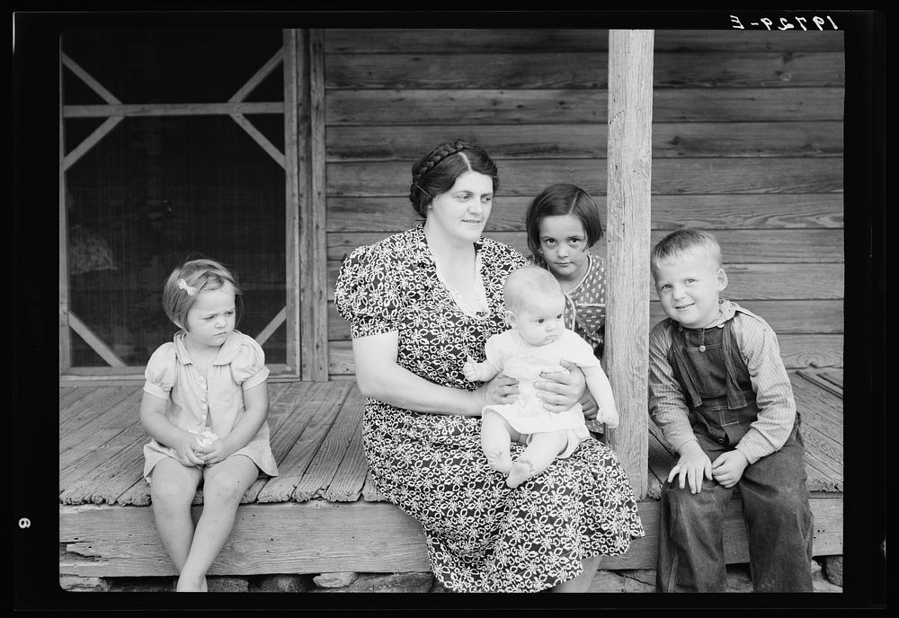 Wife and children of tobacco sharecropper on front porch. Person County, North Carolina. Sourced from the Library of…