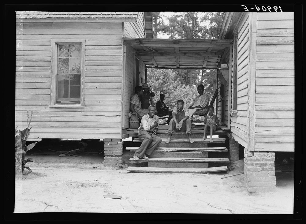 Zollie Lyons,  sharecropper, home from the field for dinner at noontime, and part of his family. Upchurch, North Carolina.…