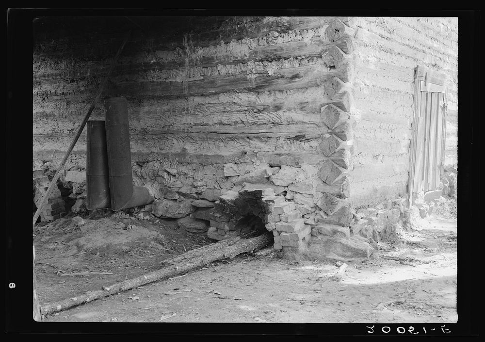 [Untitled photo, possibly related to: Construction detail of tobacco barn showing method of firing]. Sourced from the…