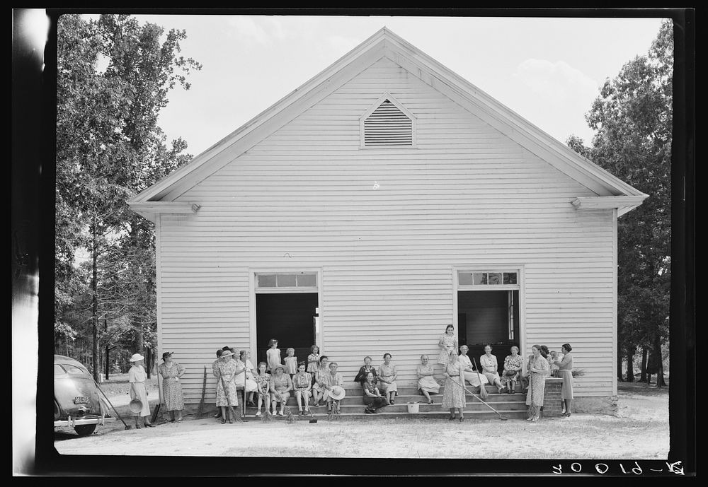 [Untitled photo, possibly related to: Women of the congregation of Wheeley's Church on steps with brooms and buckets on…