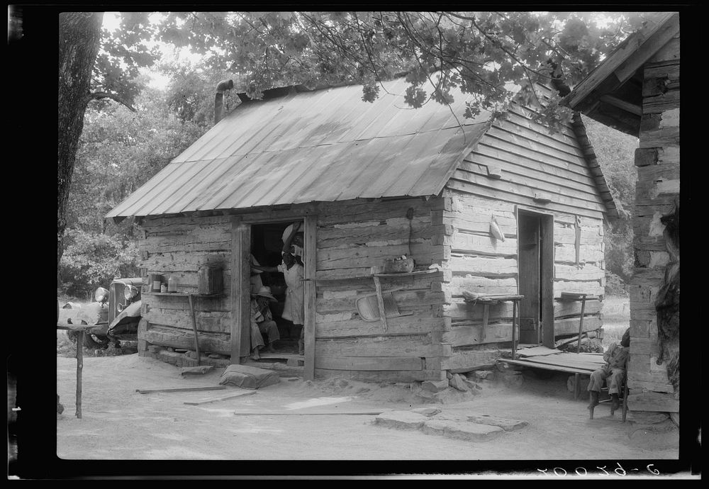 Double log cabin of  share tenants who raise tobacco. Family of eight has been on this place six or seven years. Person…