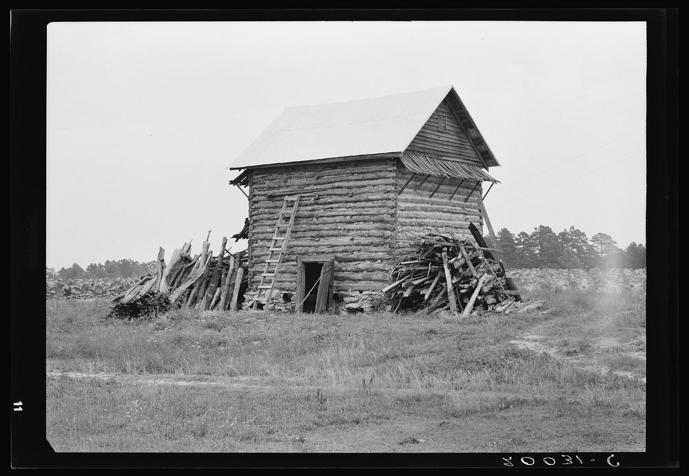 Tobacco barn without front shelter. The footpath across the field leads to the main house. Person County, North Carolina by…