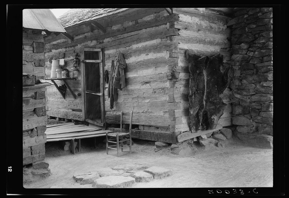 Construction detail of double log cabin of  share tenants. The cowhide was hung there after being dried on a barn to be used…