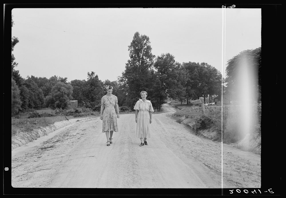 Women walking down the road to see a sick neighbor. Person County, North Carolina. Sourced from the Library of Congress.