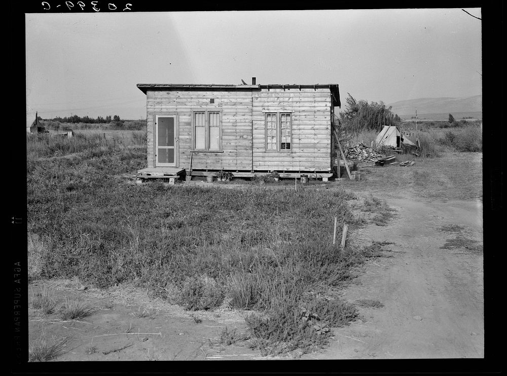 Washington, Yakima. Homes are built bit by bit with whatever materials are available. Many drought refugees settle in Sumac…