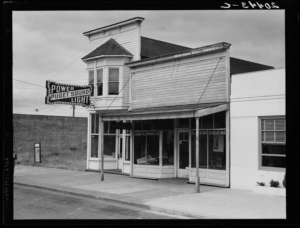 Western Washington, Grays Harbor country. Elma. Main street. Note modern building which adjoins Elma city hall. The real…