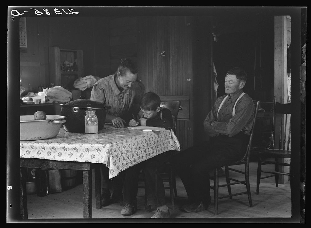 [Untitled photo, possibly related to: The Wardlow family in their dugout basement home on Sunday. The youngest boy copies…