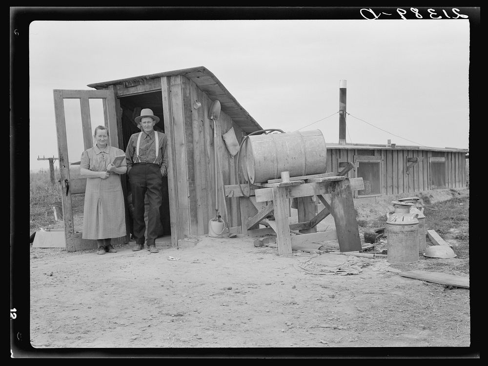 Mr. and Mrs. Wardlow at entrance to their dugout basement home. Dead Ox Flat, Malheur County, Oregon. Sourced from the…