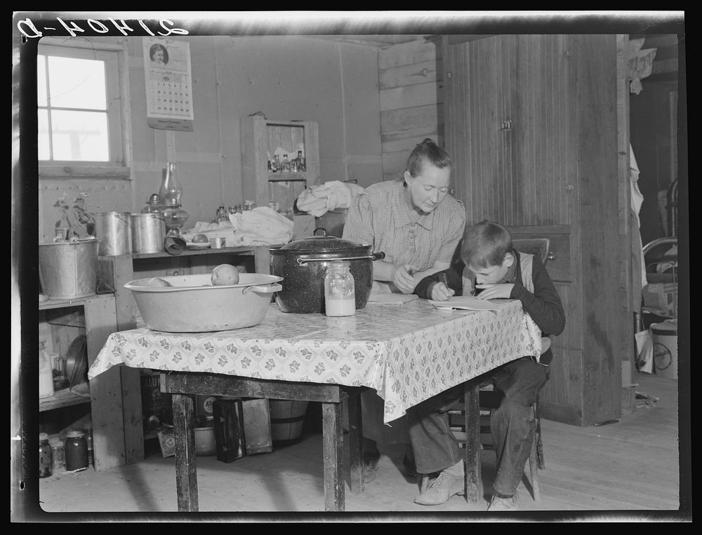 The youngest Wardlow boy copies out a recipe for his mother. Dead Ox Flat, Malheur County, Oregon. Sourced from the Library…