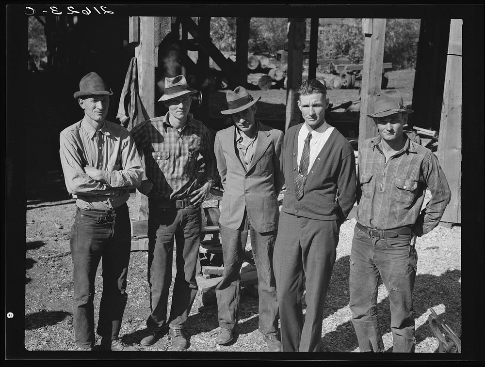[Untitled photo, possibly related to: Men working in mill. Ola self-help sawmill co-op. Gem County, Idaho. Man in rear…