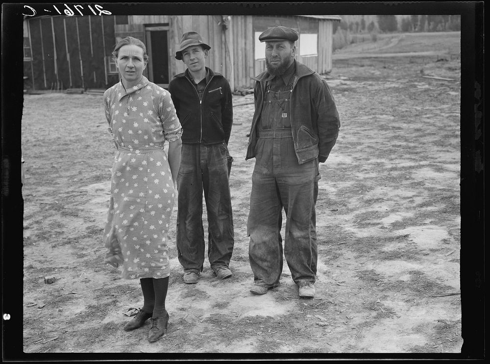 The mother, father, and hardworking fifteen-year-old son in yard before the barn. Boundary County, Idaho. See general…