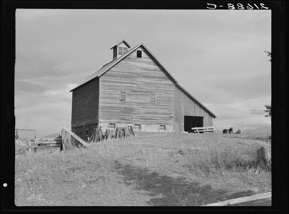 The barn of an older settler on established farm. Boundary County, Idaho.  General caption 49. Sourced from the Library of…