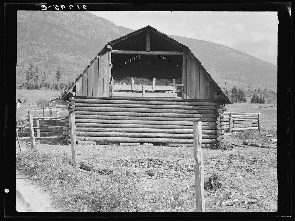 Log barn. FSA (Farm Security Administration) borrower plans to develop dairy ranch. Log home in background. Boundary County…
