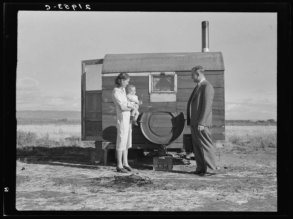 The doctor reassures the mother after having seen the sick baby in the trailer. Merrill, Klamath County, Oregon, at FSA…