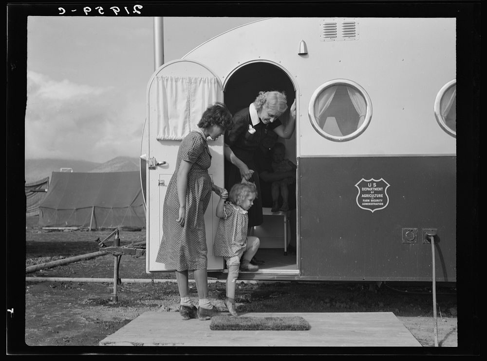[Untitled photo, possibly related to: Young mother brings her child to the trailer clinic on the day when the doctor will be…