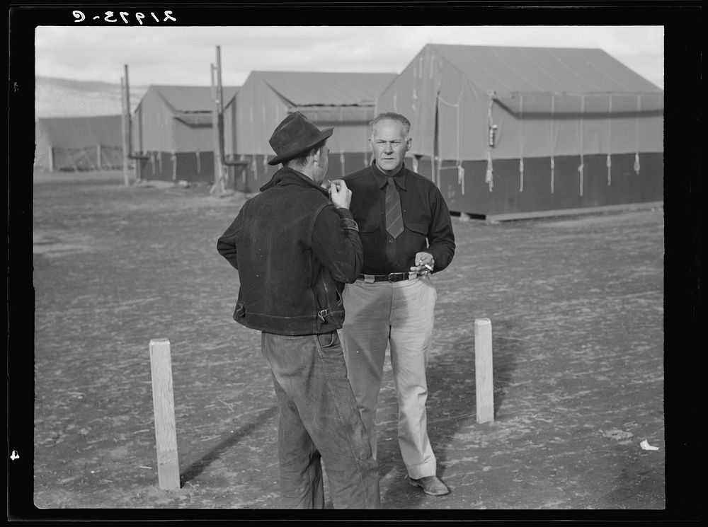 Camp manager talking to another man. FSA (Farm Security Administration) mobile camp. Merrill, Klamath County, Oregon.…