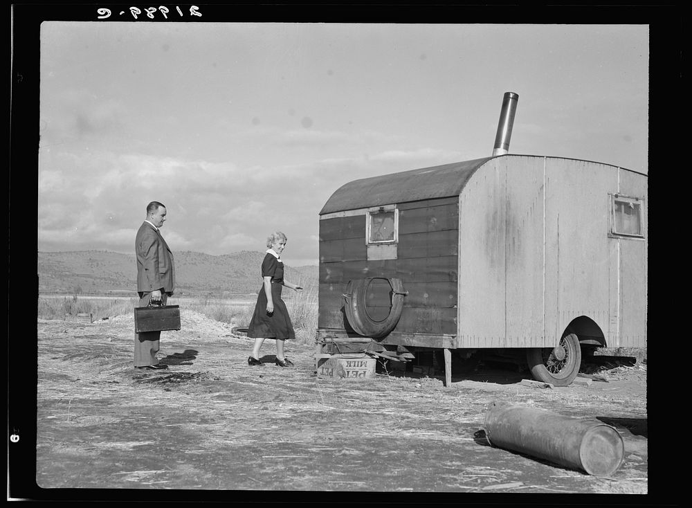 Nurse in FSA (Farm Security Administration) mobile camp unit conducts doctor to house trailer where there is a sick child.…