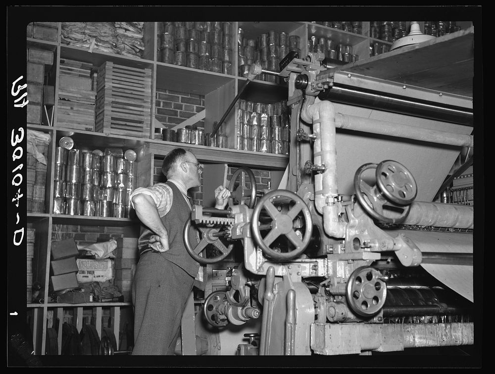 Adjusting the fibre board machine. Timber Mechanics Section, Forest Products laboratory. Madison, Wisconsin by Russell Lee