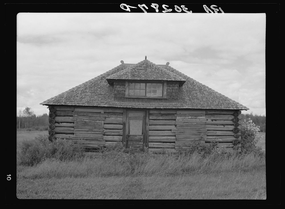 [Untitled photo, possibly related to: Abandoned log cabin near Gheen, Minnesota] by Russell Lee