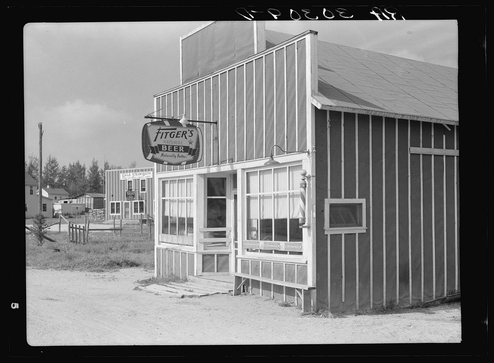 Beer parlor and barber shop. Craigville, Minnesota by Russell Lee