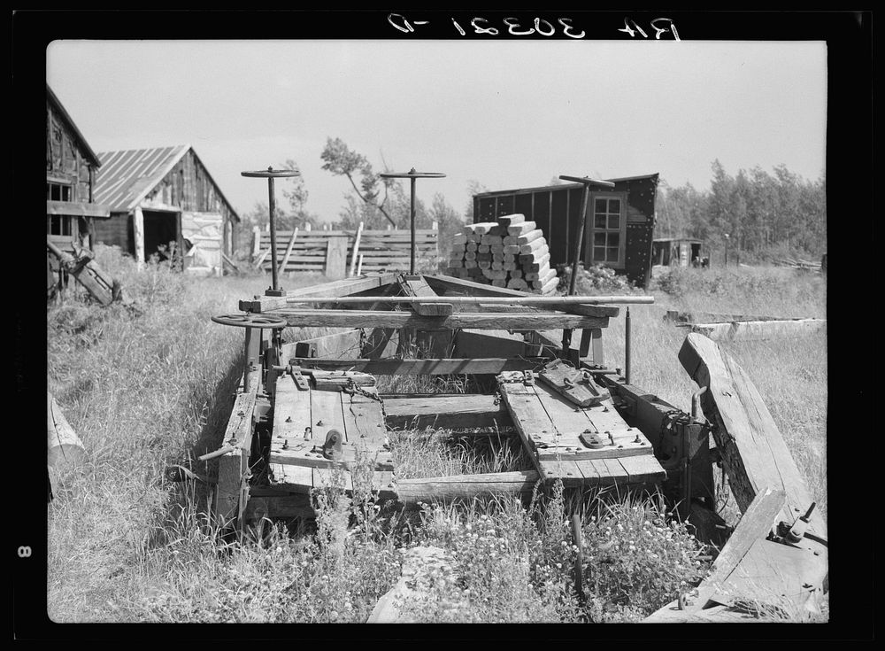 Old sled for transporting logs from forests at abandoned lumbercamp near Gemmel, Minnesota by Russell Lee