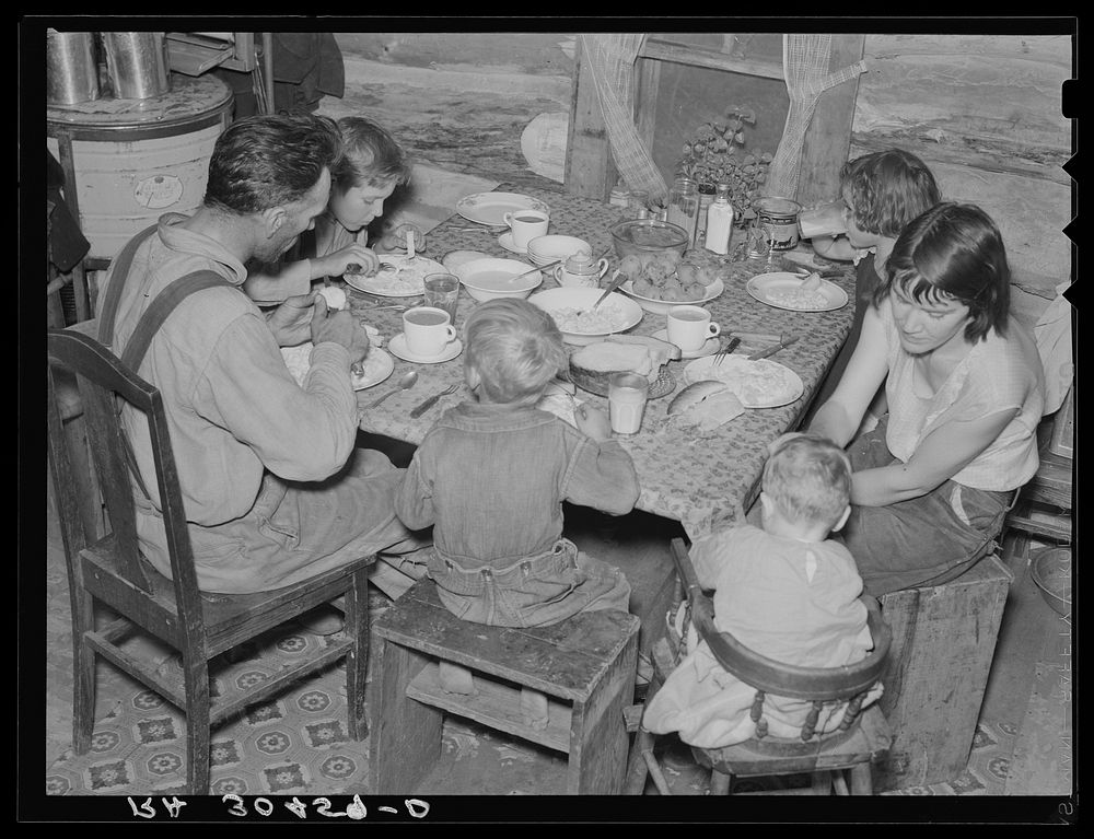 William Horavitch family eating dinner. Williams County, North Dakota by Russell Lee
