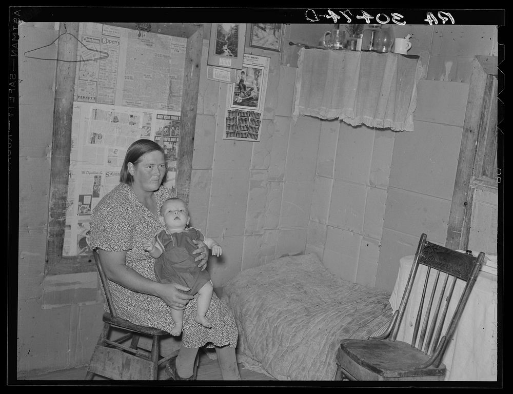 Mrs. H. Gerling and baby in living room in farmhouse near Wheelock, North Dakota by Russell Lee