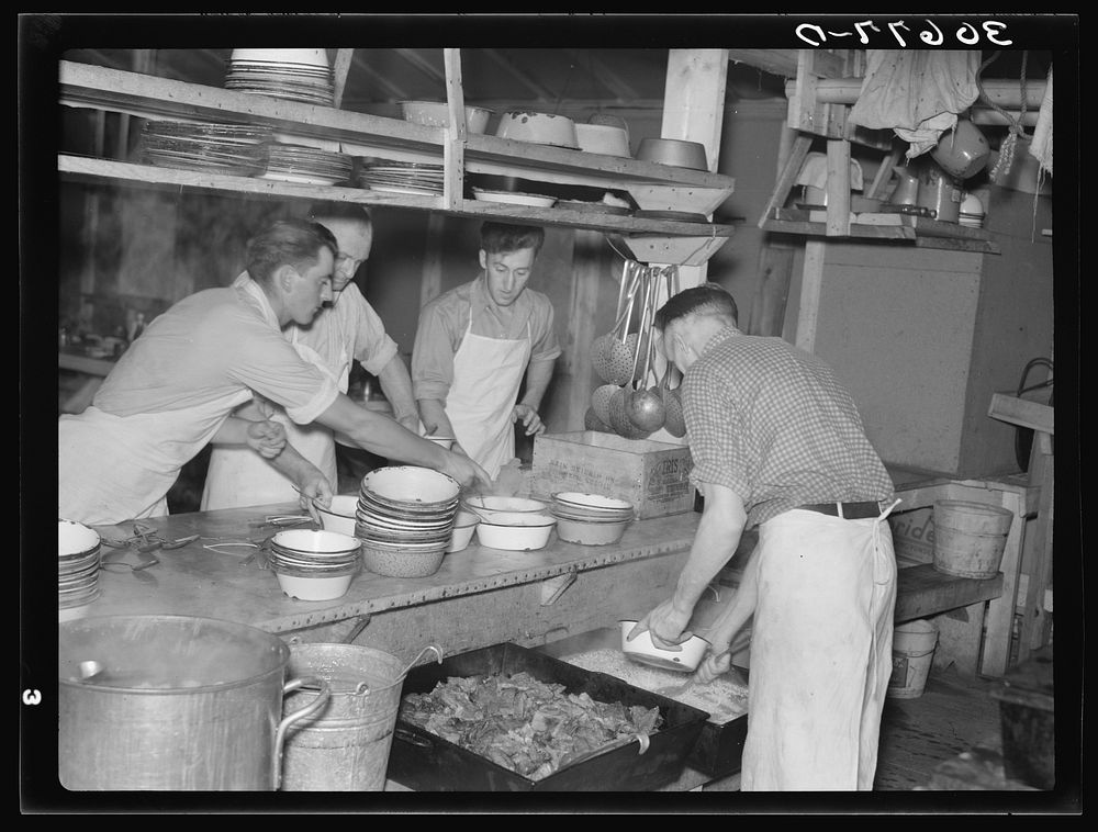 Dishing out and serving food in logging camp near Effie, Minnesota by Russell Lee