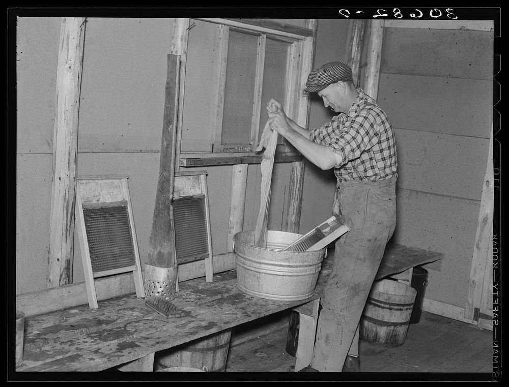 Lumberjack washing clothes. Camp near Effie, Minnesota by Russell Lee