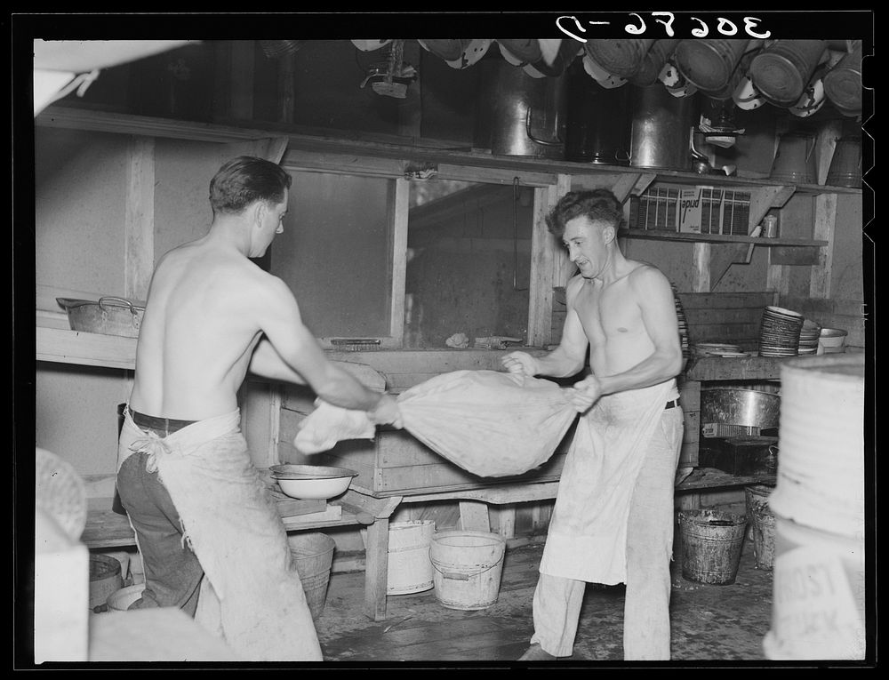 Cooks drying "silverware" in logging camp near Effie, Minnesota by Russell Lee