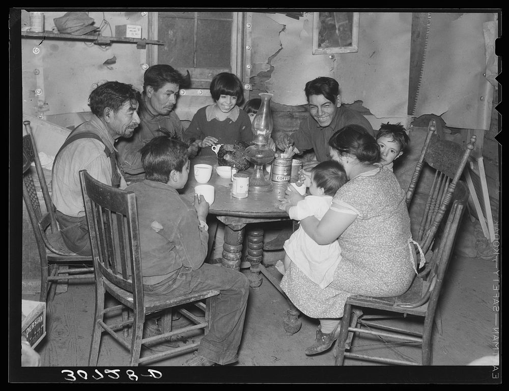 Mexican beet worker family having coffee after a day's work. East Grand Forks, Minnesota by Russell Lee