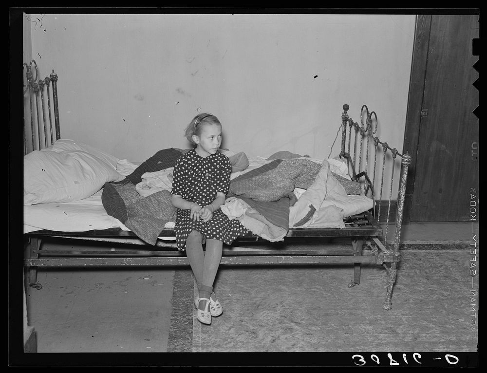 Daughter of A.O. Ryland. Family used quilts as mattresses. Near Williston, North Dakota by Russell Lee