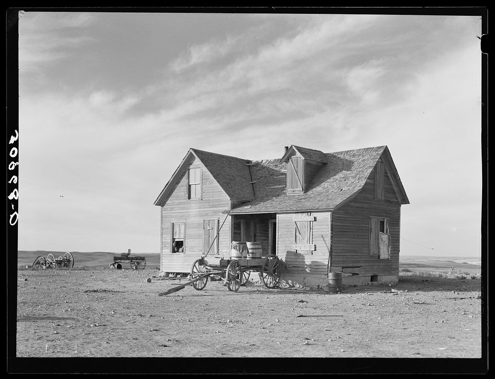 Farmhouse and wagon used for hauling water. Sheridan County, Montana by Russell Lee