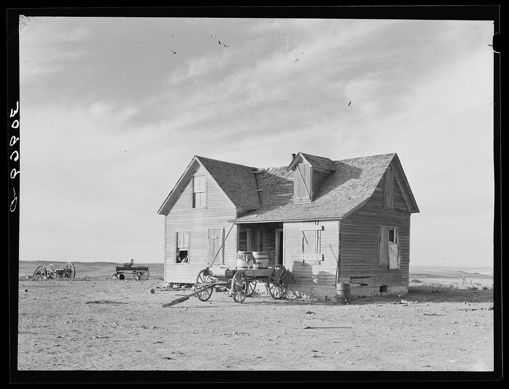 [Untitled photo, possibly related to: Farmhouse and wagon used for hauling water. Sheridan County, Montana] by Russell Lee