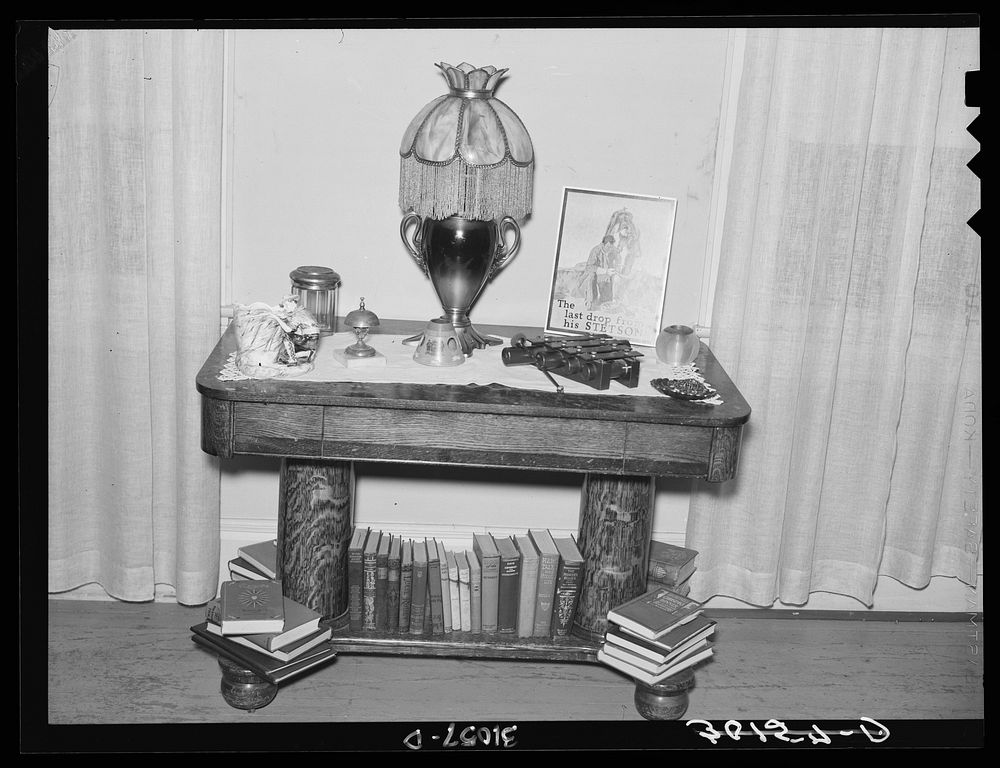 Living room table with lamp in home of Jim Hardin. Two Bit Creek, near Deadwood, South Dakota by Russell Lee