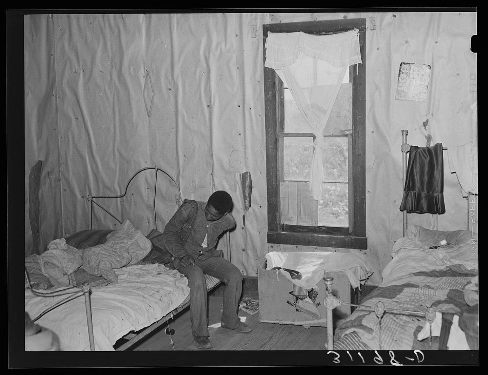 Southeast Missouri Farms. Son of sharecropper getting dressed in bedroom of shack by Russell Lee
