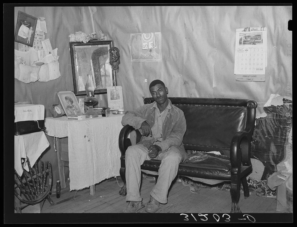 Southeast Missouri Farms. FSA (Farm Security Administration) client, former sharecropper, in living room of cabin home by…