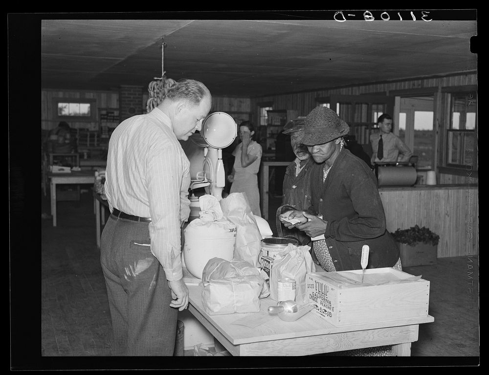 Southeast Missouri Farms. Making a purchase at cooperative store. La Forge, Missouri by Russell Lee