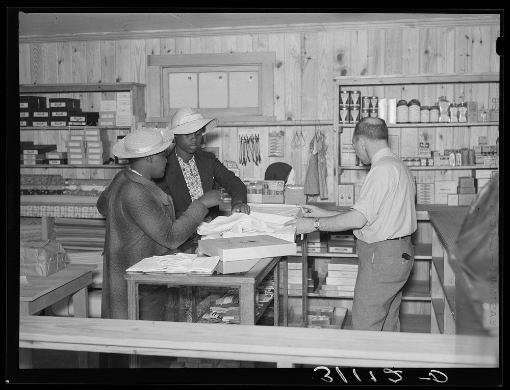 Southeast Missouri Farms. Making a purchase at cooperative store. La Forge project, Missouri by Russell Lee