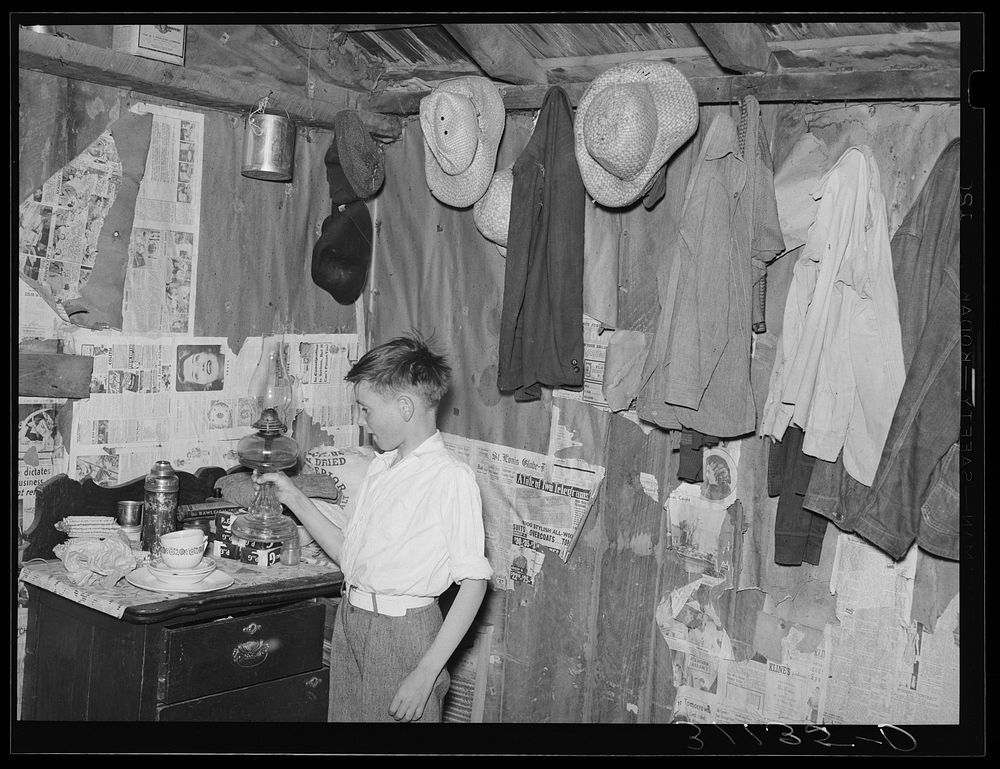 Southeast Missouri Farms. Sharecropper's son in corner of shack bedroom. La Forge project, Missouri by Russell Lee