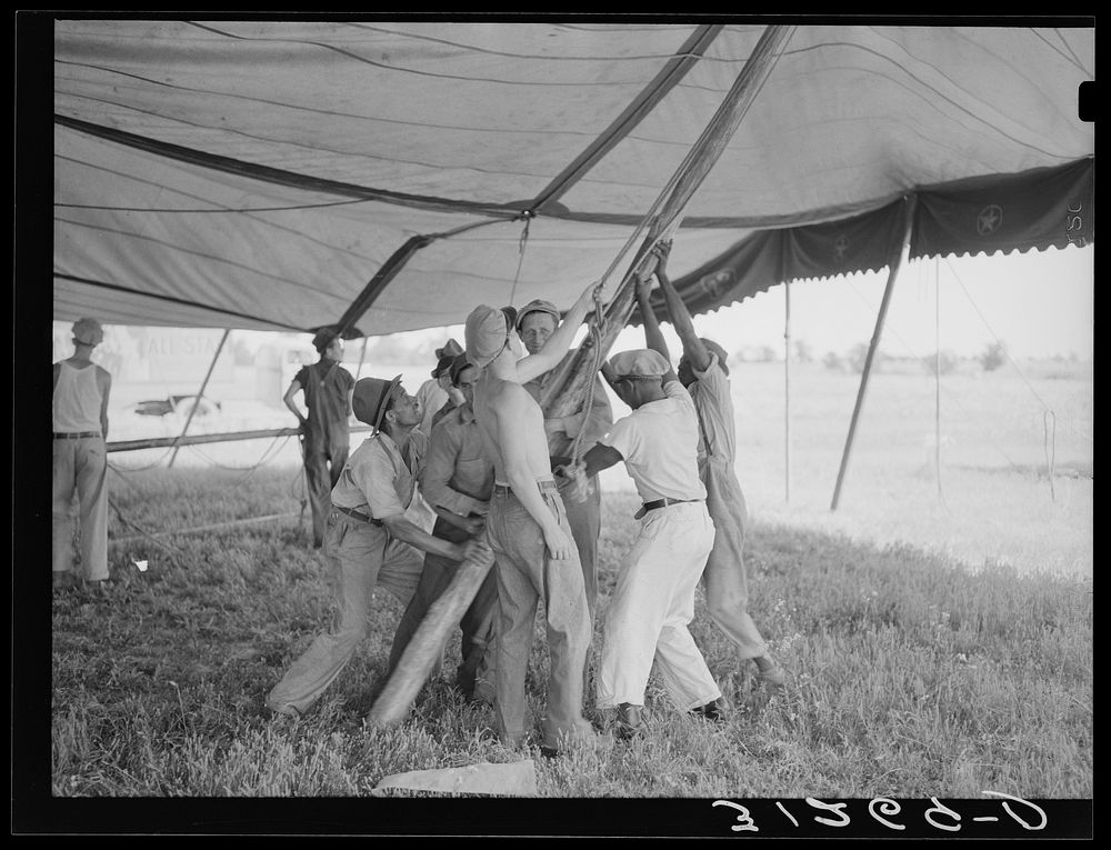 Placing pole of tent. Lasses-White show. Sikeston, Missouri by Russell Lee