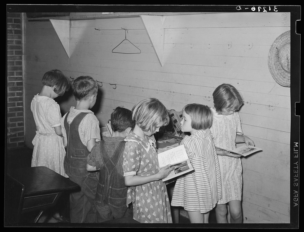 Children choosing books from the small school library near La Forge, Missouri. Southeast Missouri Farms school by Russell Lee