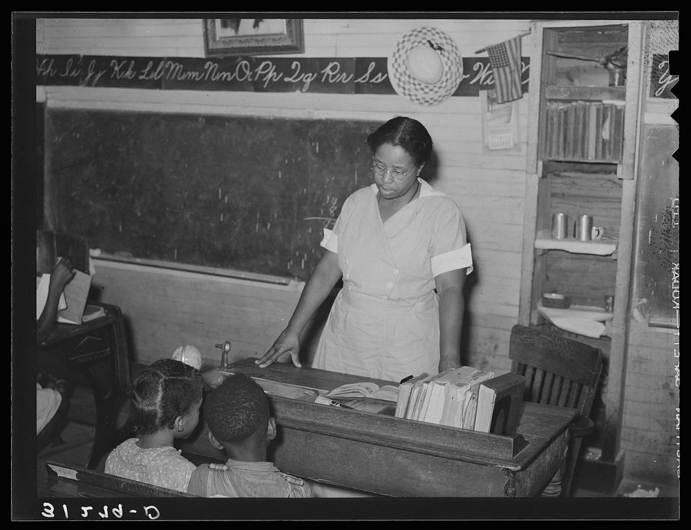 African American school teacher talking with pupils near Southeast Missouri Farms by Russell Lee