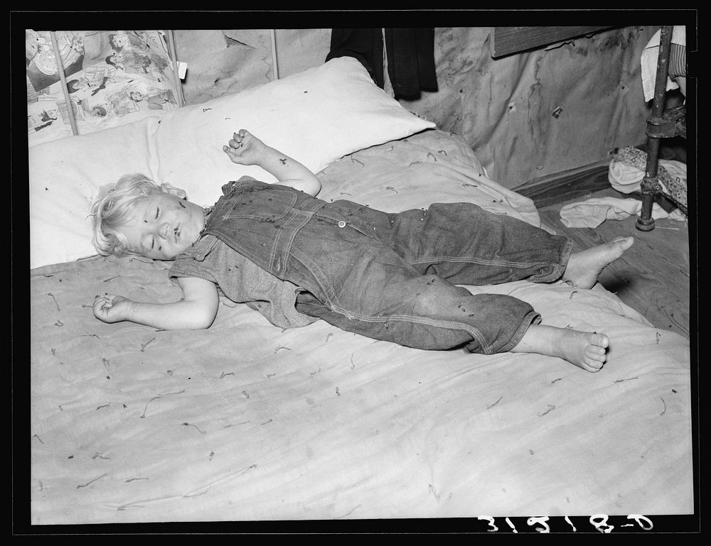 [Untitled photo, possibly related to: Southeast Missouri Farms. Sharecropper's child asleep on bed] by Russell Lee