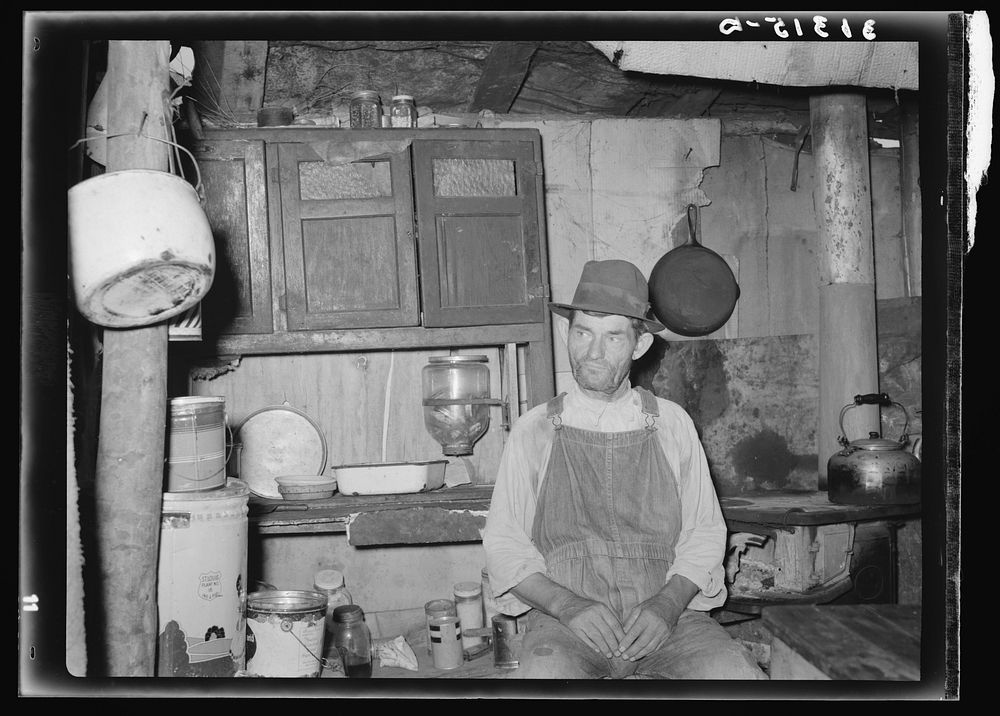 Resident of Tin Town, Caruthersville, Missouri, in his shack home by Russell Lee