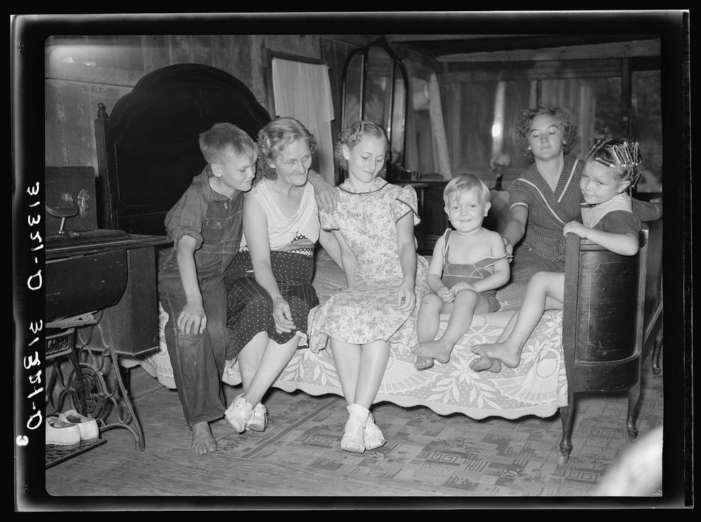Family in shack home. Tin Town, Caruthersville, Missouri by Russell Lee