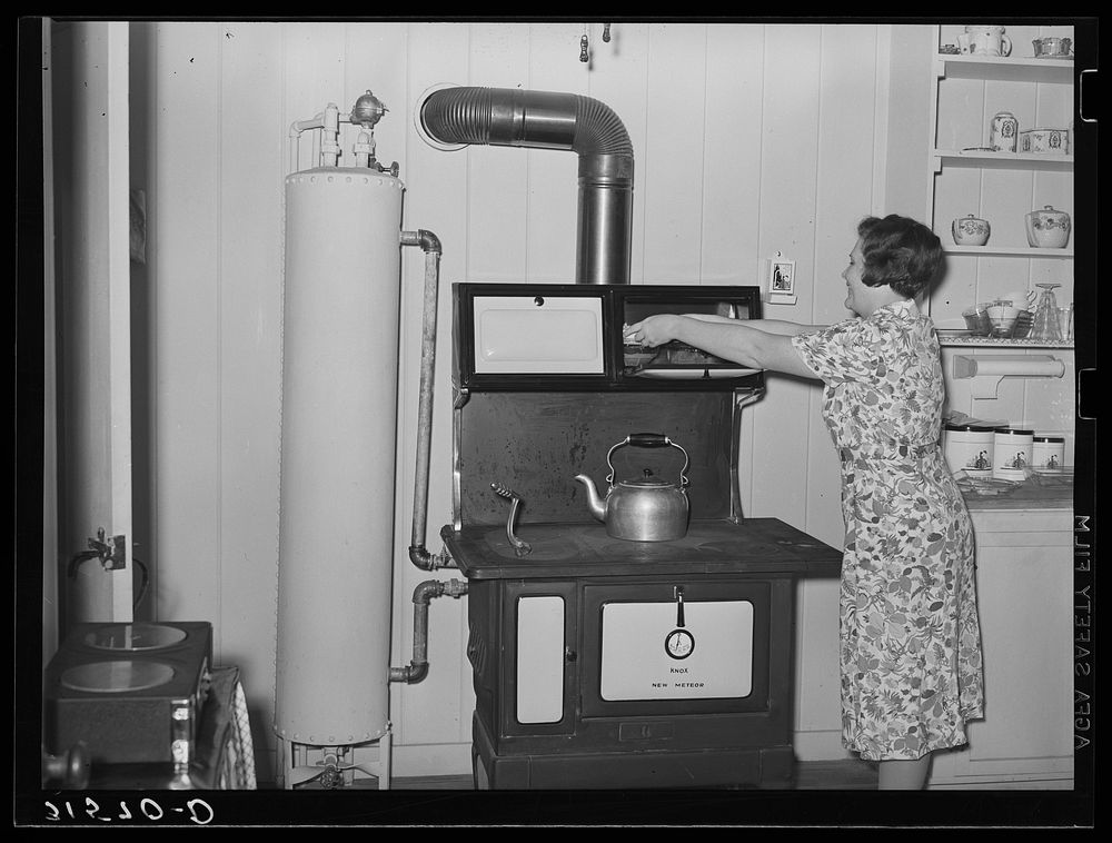 Stove and hot water boiler in farm home. Lake Dick Project, Arkansas by Russell Lee