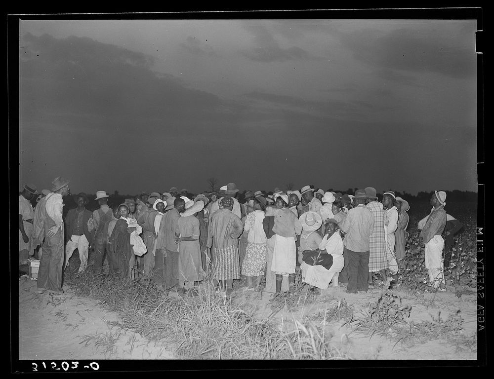 Cotton pickers, day laborers, waiting to be paid at end of day's work.  Lake Dick Project, Arkansas by Russell Lee