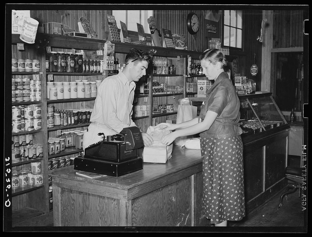 Making a purchase in cooperative stores. Lake Dick Project, Arkansas by Russell Lee