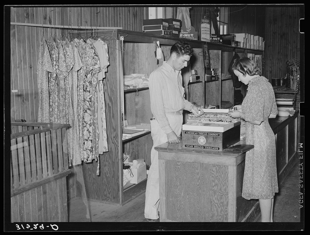 Dress and dry goods counter. Cooperative general store. Lake Dick Project, Arkansas by Russell Lee